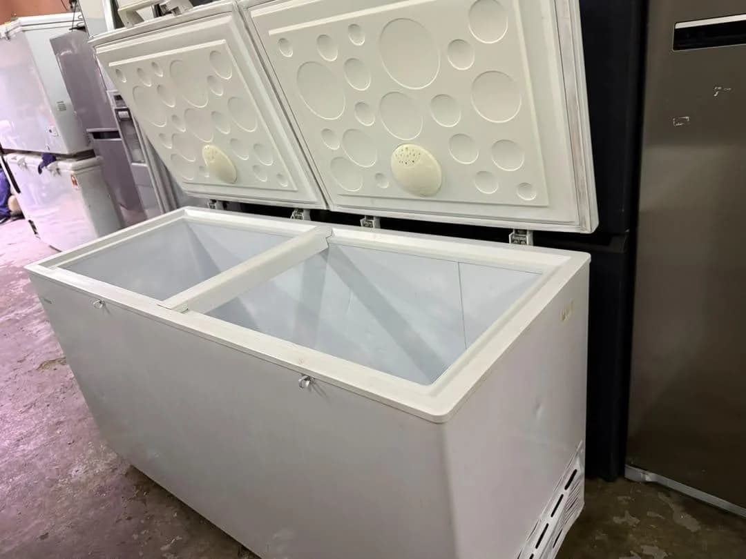 Open double-lid chest freezer showing its interior compartments