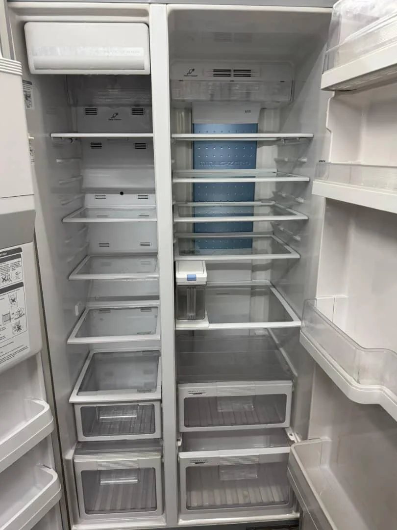Open refrigerator showing its shelves and storage drawers