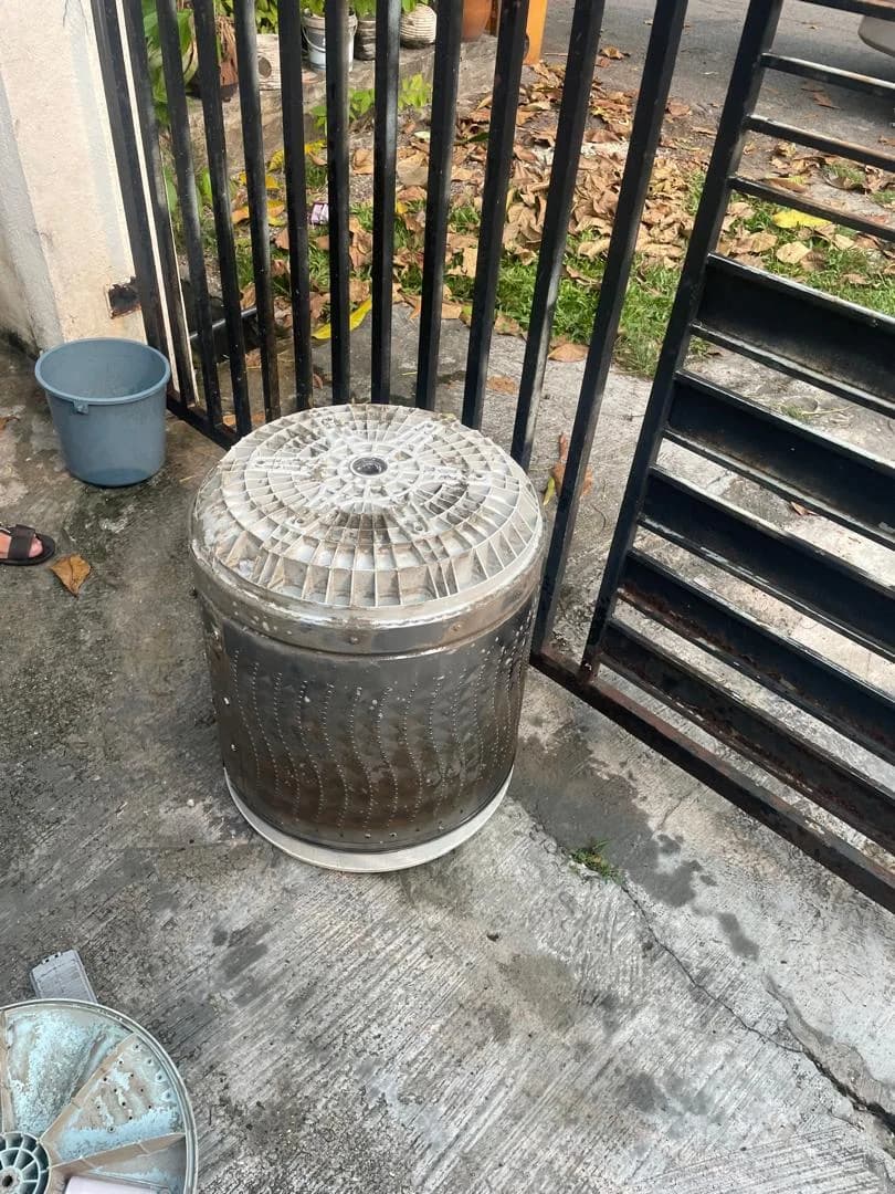 Removed washing machine drum ready for cleaning