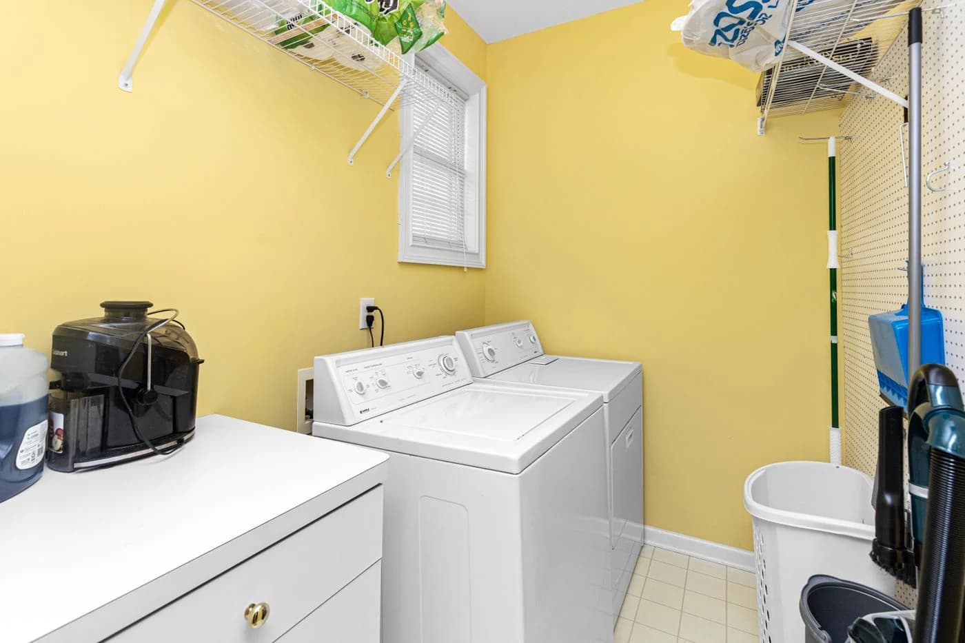White top-load washing machine in a bright laundry room